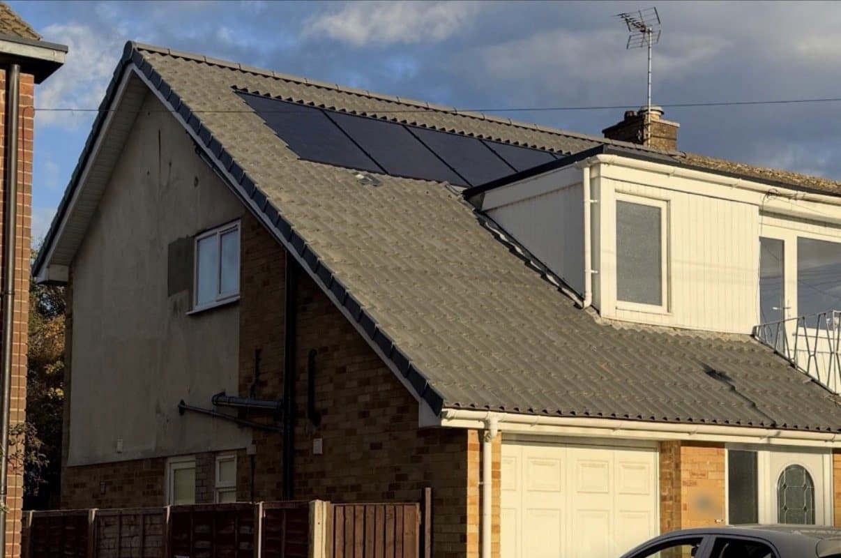 The house after, with new all-black solar panels