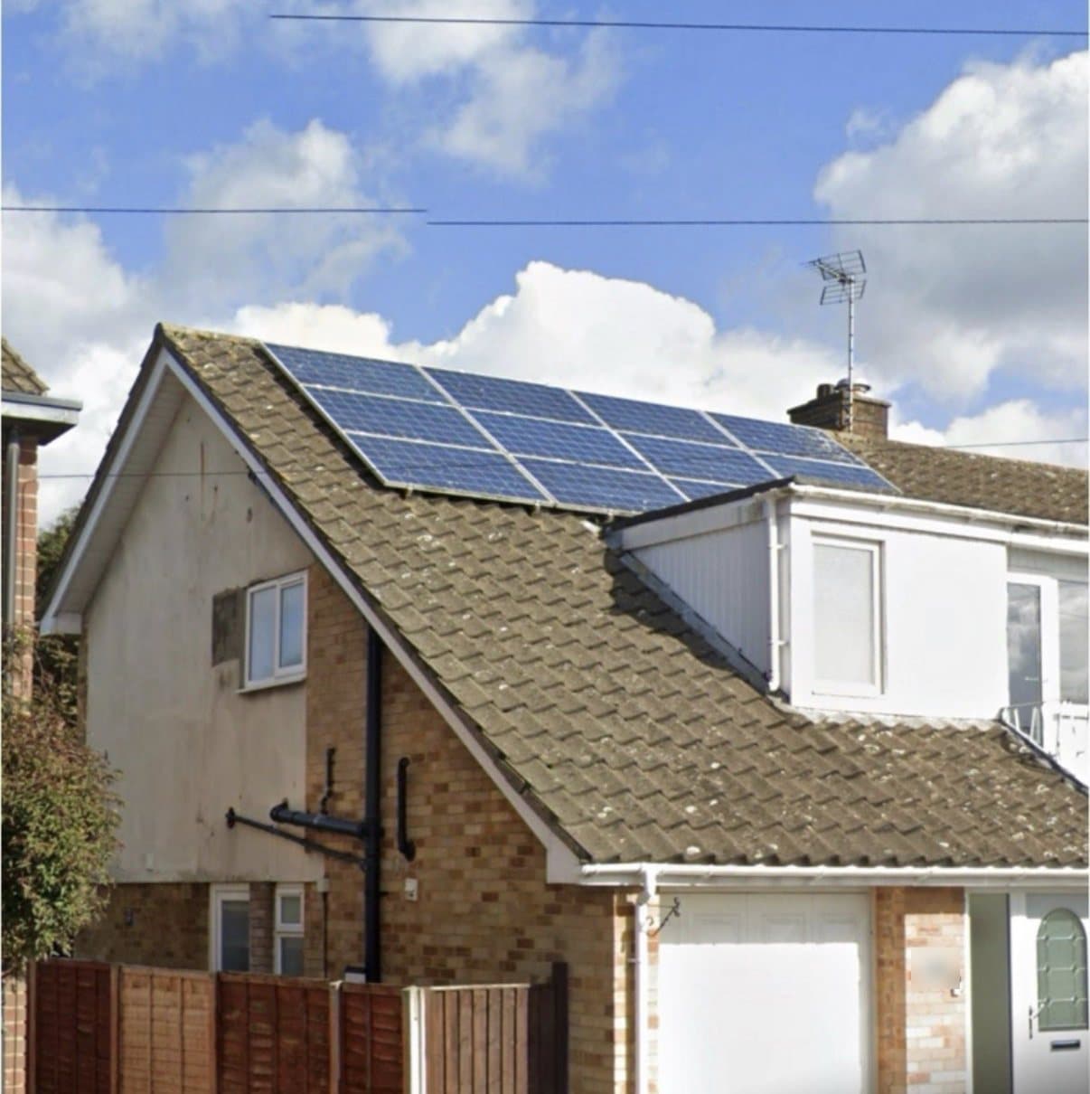 The house before, with old blue solar panels