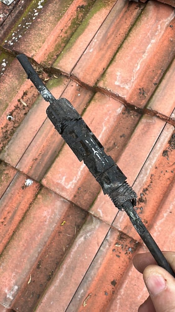 A melted, burnt-out MC4 connector found on a tiled roof