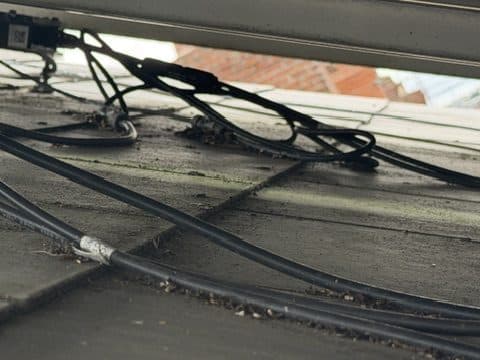 Connectors and cabling left loose on the tiles.