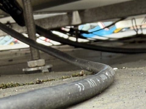 Unsupported DC cable resting on the roof surface.